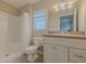 Bathroom with a shower-tub combination, a modern vanity, and a large, well-lit mirror at 1453 Ne 161St Pl, Citra, FL 32113