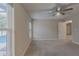 Carpeted bedroom with view of backyard pool and ceiling fan at 1453 Ne 161St Pl, Citra, FL 32113