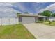 This lovely home features a wide driveway and well-manicured lawn at 1453 Ne 161St Pl, Citra, FL 32113