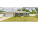 Charming single-story home boasts a well-manicured front yard and an attached two-car garage at 1453 Ne 161St Pl, Citra, FL 32113