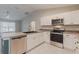 Bright kitchen with white cabinetry, stainless steel appliances, and a breakfast bar for casual dining at 1453 Ne 161St Pl, Citra, FL 32113