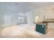 Bright, open living space with vaulted ceilings, neutral tones, and seamless flow to kitchen area at 1453 Ne 161St Pl, Citra, FL 32113