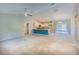 Open-concept living area boasts modern lighting, neutral carpeting, and seamless kitchen access at 1453 Ne 161St Pl, Citra, FL 32113