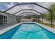 Full view of the enclosed pool, showcasing its size and the surrounding screened-in patio at 1453 Ne 161St Pl, Citra, FL 32113