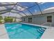 Enclosed pool with clear blue water and a screened enclosure for year-round enjoyment at 1453 Ne 161St Pl, Citra, FL 32113
