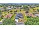 Aerial view of home and surrounding neighborhood showcasing mature trees, golf course, and landscaping at 15239 Sw 15Th Terrace Rd, Ocala, FL 34473