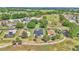 An aerial view of homes surrounding a golf course with mature trees and landscaping in a vibrant community at 15239 Sw 15Th Terrace Rd, Ocala, FL 34473