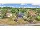 An aerial view of a landscaped home, screened lanai, mature trees, and a scenic golf course in the background at 15239 Sw 15Th Terrace Rd, Ocala, FL 34473