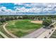 Aerial view of a well-maintained ball field surrounded by green grass, trees, and walking paths at 15239 Sw 15Th Terrace Rd, Ocala, FL 34473