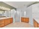 Bright bathroom with double vanities and tiled floors, featuring a glass-enclosed shower at 15239 Sw 15Th Terrace Rd, Ocala, FL 34473