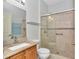 Modern bathroom featuring tile floors, a shower with glass door and vanity with granite countertop at 15239 Sw 15Th Terrace Rd, Ocala, FL 34473
