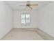 Bedroom with ceiling fan and a view to the neighborhood at 15239 Sw 15Th Terrace Rd, Ocala, FL 34473