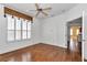 Bright bedroom with hardwood floors and a ceiling fan plus an open door to the living area at 15239 Sw 15Th Terrace Rd, Ocala, FL 34473