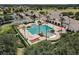 Aerial view of a large community pool area with seating, umbrellas, and lush landscaping at SummerGlen at 15239 Sw 15Th Terrace Rd, Ocala, FL 34473