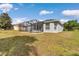 Exterior rear showcasing screened-in patio, lush yard and rear of house at 15239 Sw 15Th Terrace Rd, Ocala, FL 34473