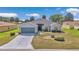 Charming single-story home featuring a well-manicured lawn, two-car garage, and inviting screened entryway at 15239 Sw 15Th Terrace Rd, Ocala, FL 34473
