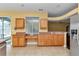 Bright kitchen with tile flooring and wooden cabinetry featuring granite countertops and lots of space at 15239 Sw 15Th Terrace Rd, Ocala, FL 34473