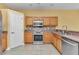 Efficient kitchen featuring stainless appliances, wood cabinets, and tile flooring at 15239 Sw 15Th Terrace Rd, Ocala, FL 34473