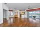 Open living room featuring hardwood floors, neutral paint, and sliding glass doors leading to the lanai at 15239 Sw 15Th Terrace Rd, Ocala, FL 34473