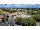 Aerial view of the neighborhood pool and clubhouse, with surrounding homes and lush landscaping at 15239 Sw 15Th Terrace Rd, Ocala, FL 34473