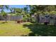 Spacious backyard featuring a well-maintained lawn, landscaping, and a privacy fence at 2219 Ne 18 Ave, Ocala, FL 34470