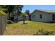 Spacious backyard featuring lush lawn, mature trees, and storage sheds at 2219 Ne 18 Ave, Ocala, FL 34470