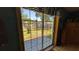 View of the backyard through sliding glass doors with a patio and fenced yard at 2219 Ne 18 Ave, Ocala, FL 34470