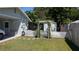 Charming backyard featuring a white picket fence with vine-covered pergola at 2219 Ne 18 Ave, Ocala, FL 34470