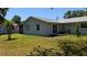 Spacious backyard with lawn, mature trees, storage shed, and view of the home's exterior at 2219 Ne 18 Ave, Ocala, FL 34470