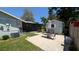 View of the back yard with a patio, shed, and screened in lanai at 2219 Ne 18 Ave, Ocala, FL 34470