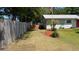 Well-maintained front yard with a flagpole, palm tree, and charming single-story home at 2219 Ne 18 Ave, Ocala, FL 34470