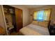 Bedroom with warm, natural light, golden walls, and wooden floors at 2219 Ne 18 Ave, Ocala, FL 34470