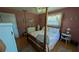 Bright bedroom with a four-poster bed, complementary furnishings, and warm natural light at 2219 Ne 18 Ave, Ocala, FL 34470