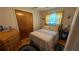 Cozy bedroom features warm-toned decor, wood floors, and ample natural light at 2219 Ne 18 Ave, Ocala, FL 34470