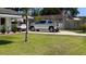 A long driveway leads up to a home with a silver pickup truck parked in front at 2219 Ne 18 Ave, Ocala, FL 34470