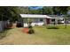 Well-maintained front yard with a flagpole, palm tree, and charming single-story home at 2219 Ne 18 Ave, Ocala, FL 34470