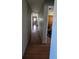 Long hallway with wood flooring and a view towards rooms with barn doors at 2219 Ne 18 Ave, Ocala, FL 34470