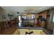 Open-concept kitchen with wooden cabinets, granite counters, and a rustic wood-paneled island at 2219 Ne 18 Ave, Ocala, FL 34470
