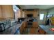 Updated kitchen with stainless steel appliances, decorative backsplash, and wooden cabinets at 2219 Ne 18 Ave, Ocala, FL 34470