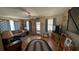 Inviting living room with comfortable sofas, ceiling fan, and a view to the lanai at 2219 Ne 18 Ave, Ocala, FL 34470