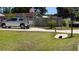 A long driveway leads up to a home with a silver pickup truck parked in front at 2219 Ne 18 Ave, Ocala, FL 34470