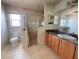 Bright bathroom features a glass shower, single sink vanity, and tiled floor at 26 Hemlock Circle Way, Ocala, FL 34472