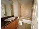 This bathroom includes a vanity with sink, toilet, and a tub with tiled walls at 26 Hemlock Circle Way, Ocala, FL 34472