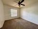 Bedroom with carpet, a ceiling fan, and a window for natural lighting at 26 Hemlock Circle Way, Ocala, FL 34472
