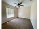 Bedroom with a ceiling fan, neutral walls and carpet, and natural light from window at 26 Hemlock Circle Way, Ocala, FL 34472