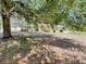 Single-story home with mature tree shading the front yard at 26 Hemlock Circle Way, Ocala, FL 34472