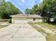 Side view of home showing garage, driveway, and part of the yard at 26 Hemlock Circle Way, Ocala, FL 34472
