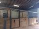 Clean, well-lit barn interior with sturdy wooden stalls, offering a secure and comfortable equestrian space at 2630 Nw 140Th St, Citra, FL 32113