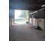 Bright barn interior featuring horse stalls and an open entrance, providing a comfortable equestrian environment at 2630 Nw 140Th St, Citra, FL 32113