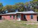 Charming single-story home featuring an entrance porch, a metal roof and several windows at 2630 Nw 140Th St, Citra, FL 32113